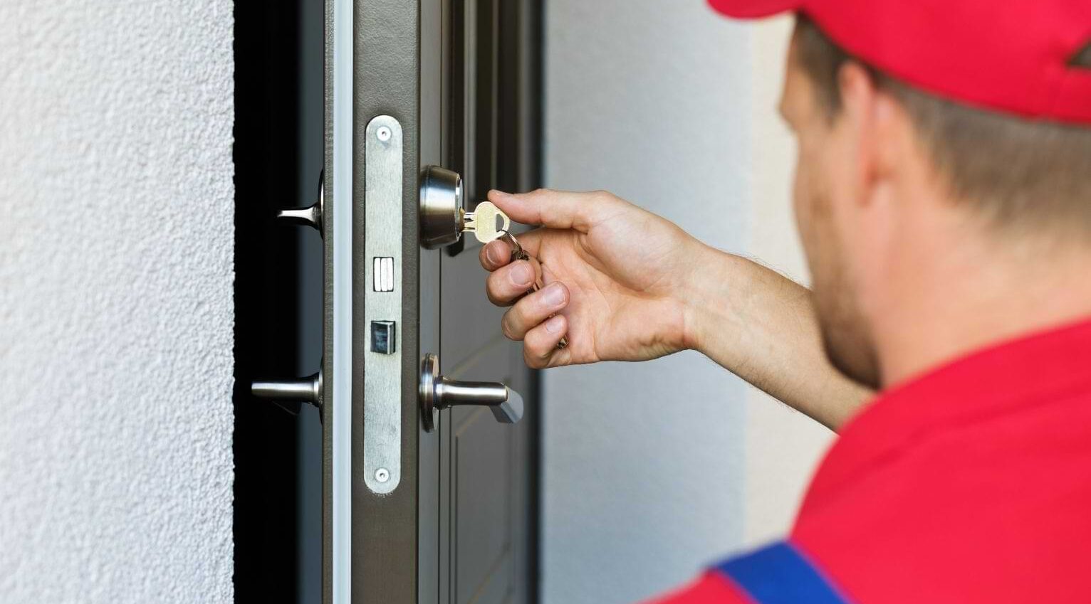 Locker Smith locksmith fixing a front door lock in London